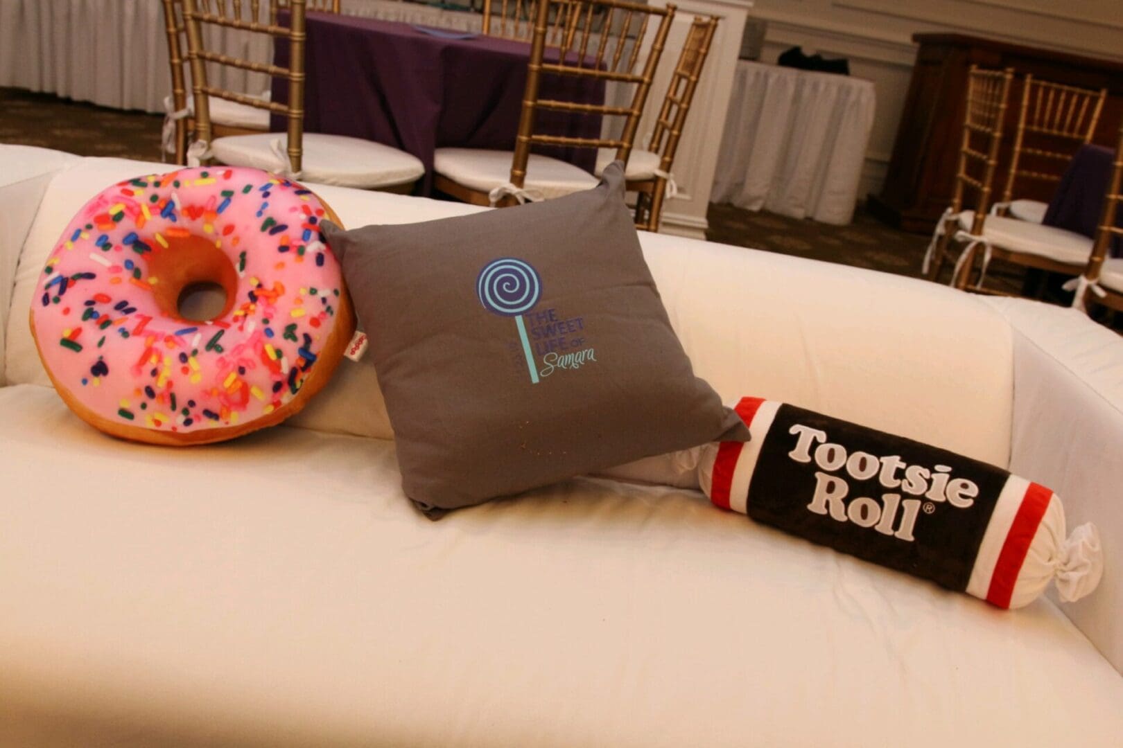 A table with two pillows and a donut.