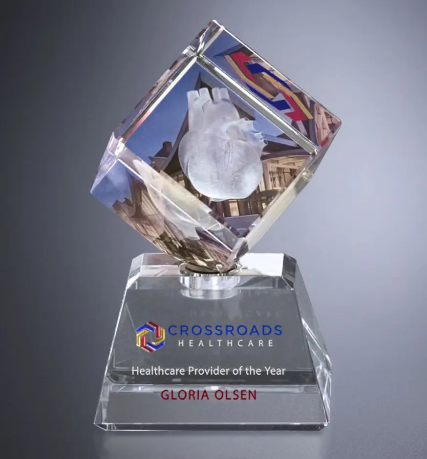 A glass award with an image of the city.