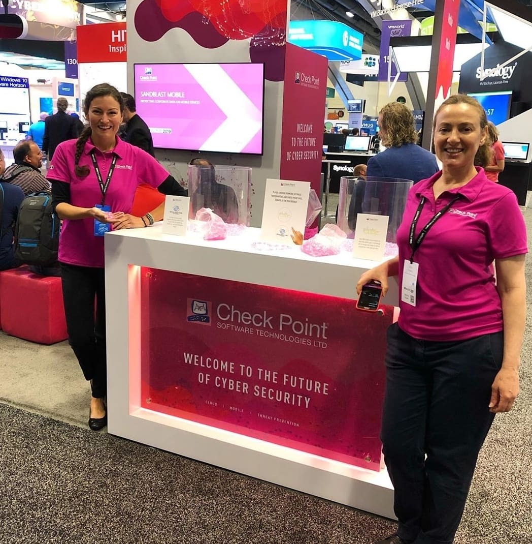 Two women standing in front of a counter.