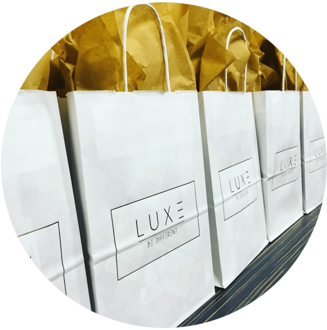 A row of white bags sitting on top of a table.