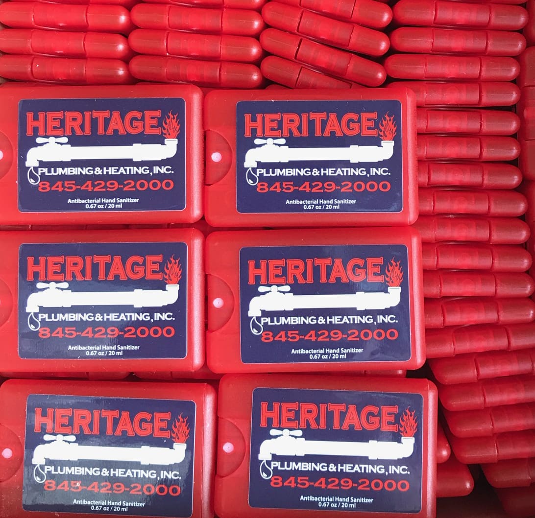 A stack of red hot dogs with heritage logo on them.