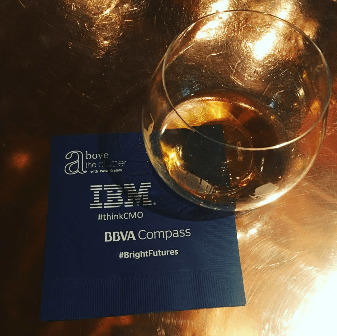 A glass of wine and an ibm logo on the table.