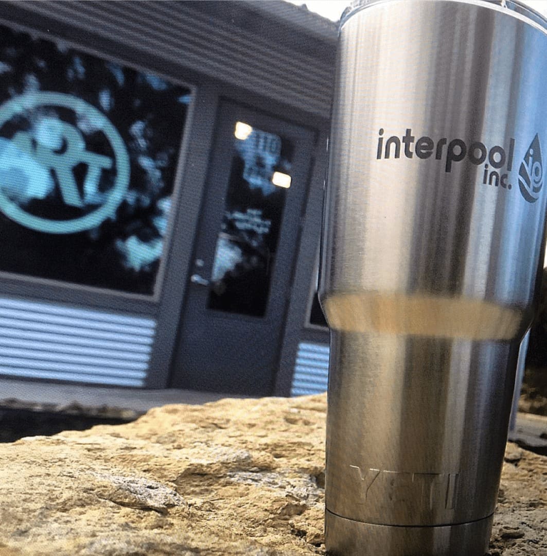 A stainless steel cup sitting on top of a table.